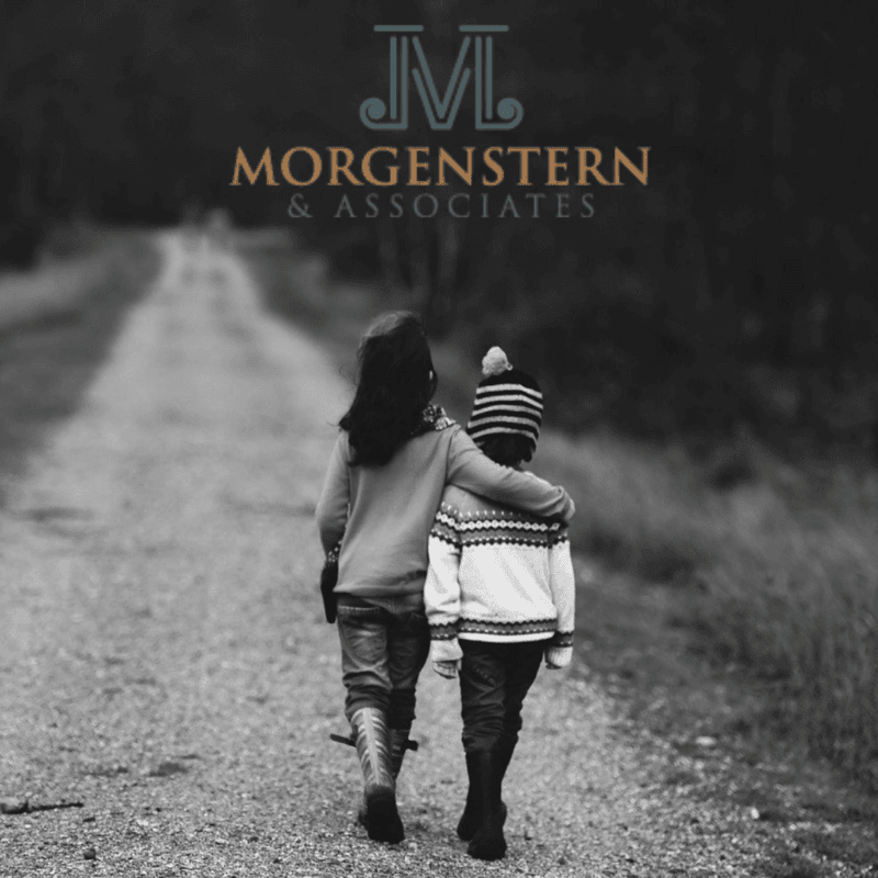 2 kids walking down a path