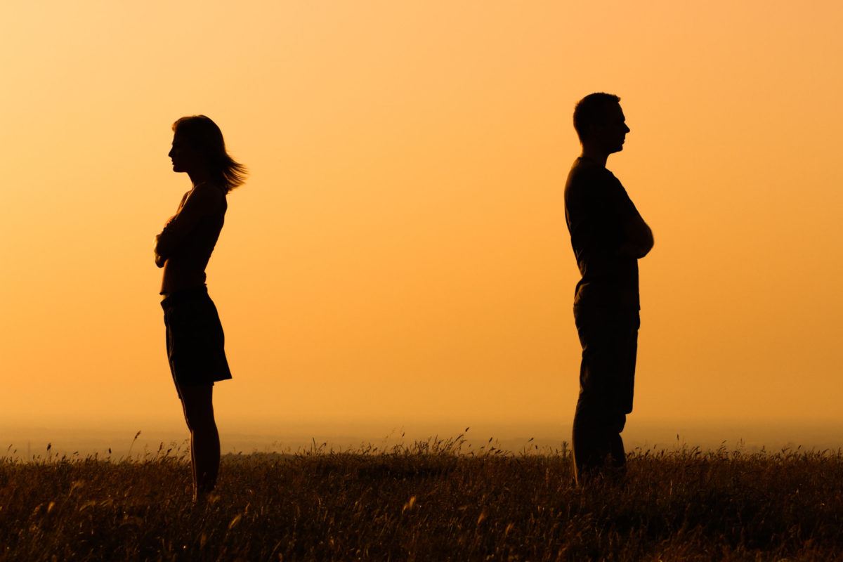 couple standing back to back
